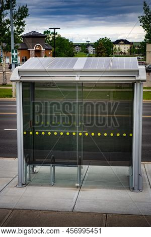 Airdrie Alberta Canada, June 12 2022: Bus Stop Transit Shelter With Solar Panels On The Roof For Sus