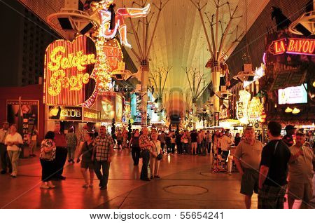 LAS VEGAS, US - OCTOBER 13: Ambiance in Fremont Street at night on 13, 2011 in Las Vegas. There are the older casinos and most of the icons of the city, such as the cowgirl neon sign of Glitter Gulch
