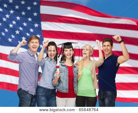 education and people concept - group of standing smiling students with diploma and corner-cap