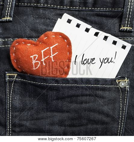 BFF I love you! written on a peace of paper and a heart on a jeans background