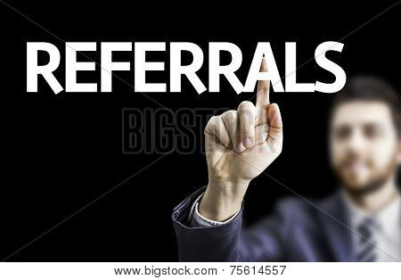 Business man pointing to black board with text: Referrals