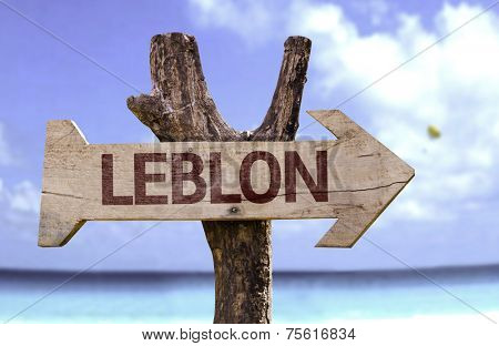 Leblon wooden sign with a beach on background