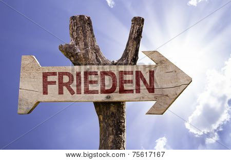 Peace (In German) wooden sign on a beautiful day