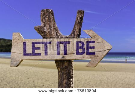 Let It Be wooden sign with a beach on background