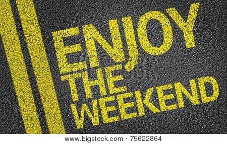 Happy Enjoy the Weekend written on the road