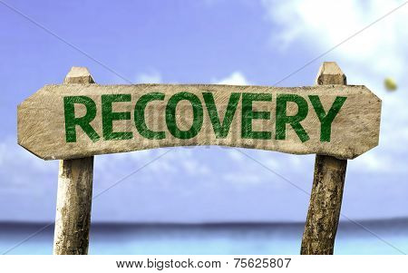 Recovery wooden sign with a beach on background