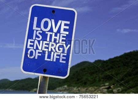 Love is The Energy of Life sign with a beach on background
