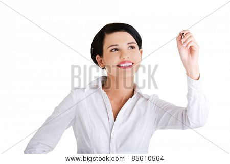 Happy businesswoman drawing on a glassboard