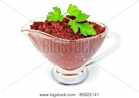 Adjika in glass gravy boat with parsley