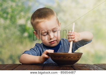 Cute Little Boy Eats Outdoors