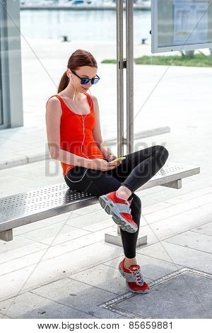 Sport woman at the bus station