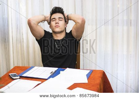 Tired Or Despondent Young Man Doing Homework