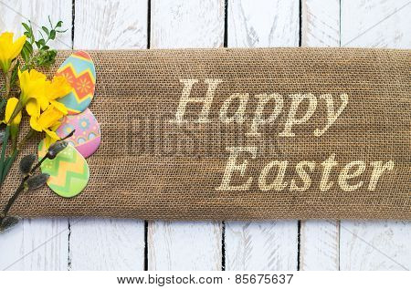Colorful easter eggs on linen cloth with Happy Easter text