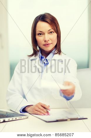 medicine and healthcare concept - busy doctor with laptop computer