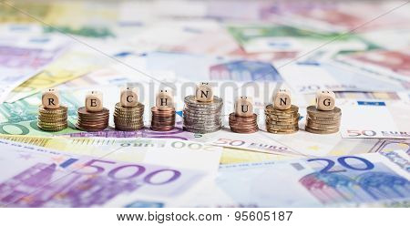 German Word Rechnung On Coin Stacks, Cash Background
