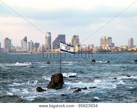 Flag Of Israel On The Andromeda Rocks On The Background Of Tel Aviv