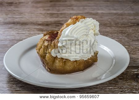 Savarin with whipped cream placed on a plate