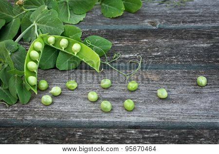 Peas on wooden background