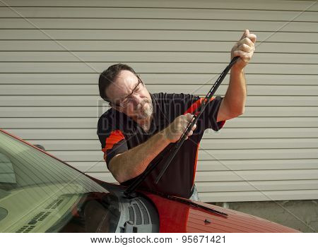 Mechanic Replacing Wiper Blades On A Car