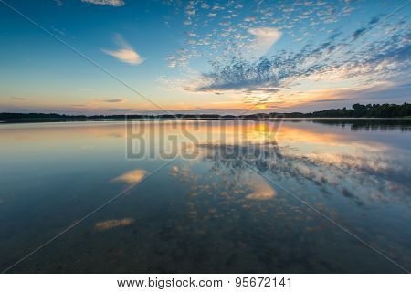 Beautiful Lake At Sunset Landscape With Cloudy Sky Reflecting In Water
