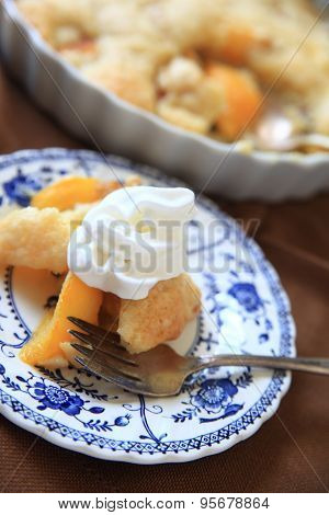 Fresh peach cobbler with whipped cream