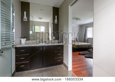 Modern master bathroom next to a bedroom. Interior design.