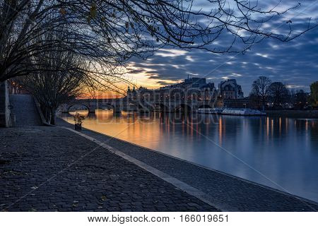 Sunrise on the Seine River banks (Quai des Tuilleries) and Ile de la Cite. 1st Arrondissement Paris France