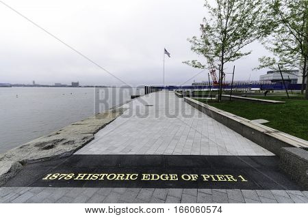 South Boston Massachusetts USA - July 7 2016: Marker on Harborwalk shows where Fan Pier has been extended and renovated in recent redevelopment of Seaport District