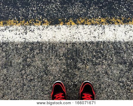 alone person is waitting near the asphalt road
