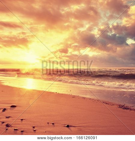 Beach Sand With Stones And Water Trails. Traces On Beach At Smooth Sea,