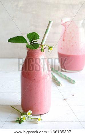 frest tasty strawberry smoothie with yoghurt in glass bottle