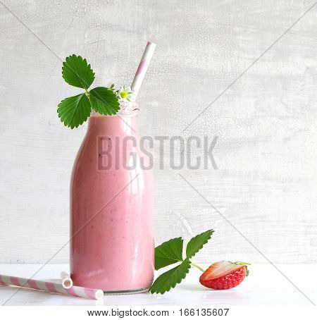frest tasty strawberry smoothie with yoghurt in glass bottle