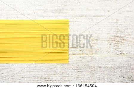 Italian raw pasta on a white surface. Top view copy space.