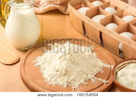 ingredients for making pancakes on a wooden table