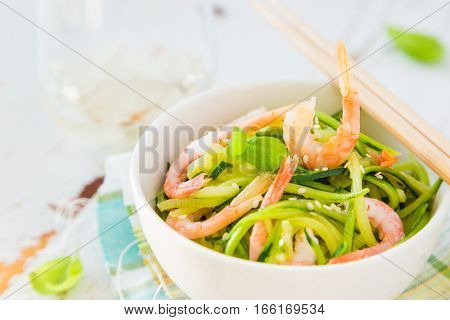 Zucchini pasta in white bowl, copy space