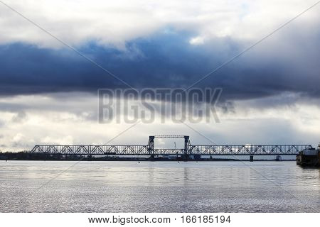 white cumulus clouds pass bridge over the Northern Dvina River