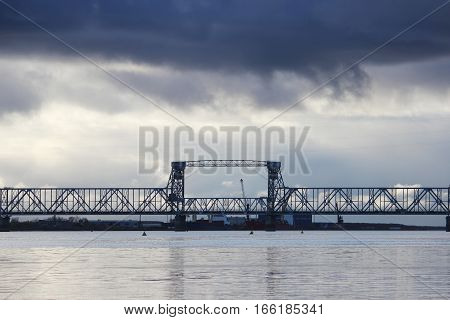white cumulus clouds pass bridge over the Northern Dvina River