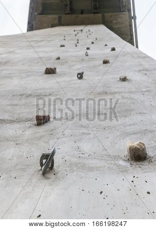 Climbing grips and hooks attached to bridge pillar wall Maro Spain