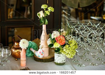 The wedding buffet table and vases with flowers