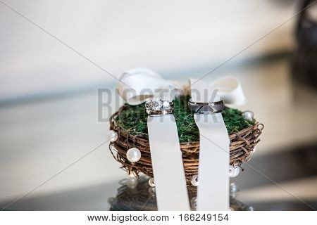 Wedding ring bands on a rustic ring holder