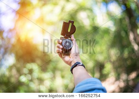 Magnetic compass in hand traveler. Tools to guide in the journey.