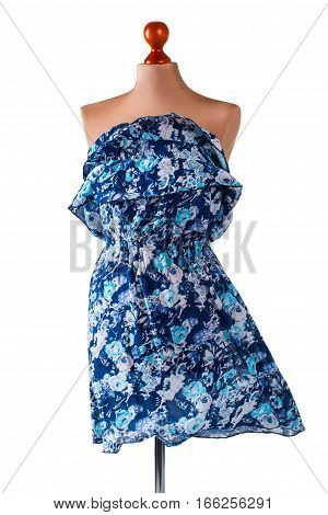 Casual blue floral dress. Blue dress on armless mannequin. New garment in fashion boutique. Strapless dress in the wind.