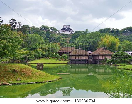 Genkyuen Garden in Hikone, Shiga Prefecture, Japan. Genkyuen Garden is a Japanese garden with a central pond and a circular walking trail. It was built on the grounds of Hikone Castle in 1677.