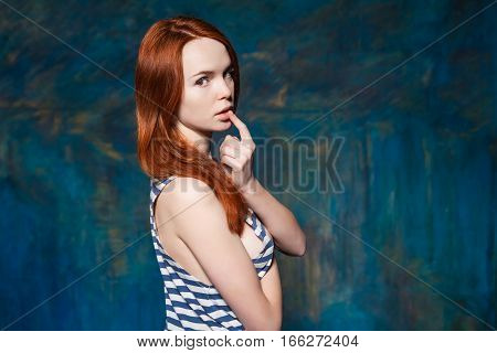 sexy young teenager in striped tshirt. Keep a finger near lips