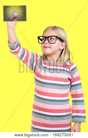 education, school and imaginary screen concept - cute little girl drawing in the air or imaginary screen
