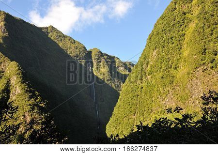 High Waterfall on the Mountains with Vegetation in the Reunion Island