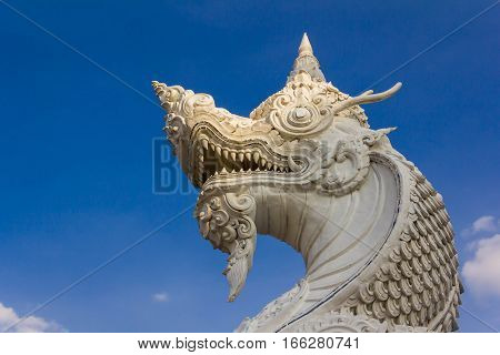 stone serpent king of Nagas near the river in blue sky