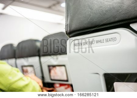 Close Up Fasten Seat Belt At Backrest On Airplane