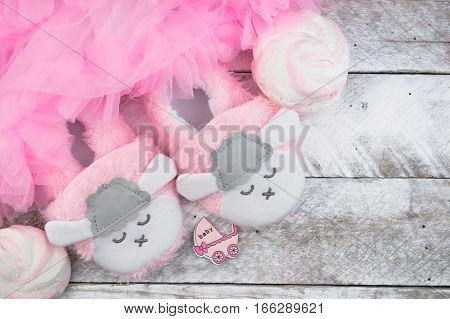 Little girlie baby shoes on a wood