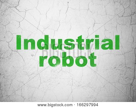 Manufacuring concept: Green Industrial Robot on textured concrete wall background